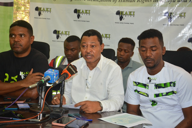 Haki Afrika director Yusuf Abubakar accompanied by the executive director Khalid Hussein and Mathias Shipeta address journalists at their offices in Mombasa on Thursday.