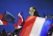 French presidential candidate for the En Marche! movement Emmanuel Macron kisses his wife Brigitte Trogneux on stage at the Parc des Expositions in Paris.