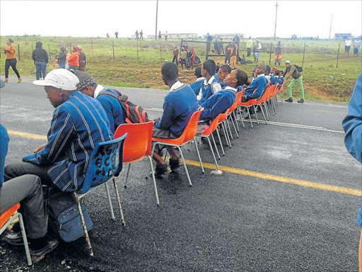 MAKING THEIR VOICES HEARD: Pupils from Emdeni Senior Secondary School staged an unusual protest last week by sitting in the middle of the road demanding a decent school Picture: SUPPLIED