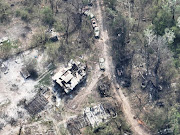 An aerial view of destroyed buildings and burnt vehicles on the banks of Siverskyi Donets River, eastern Ukraine, in this handout image uploaded on May 12, 2022. 