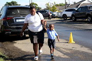 Mpilwenhlwe Mjwacu, 5, arriving with his mom Ntombiyovuyo on his first day at Kwa-Zubumnandi preschool in Umlazi on Wednesday.