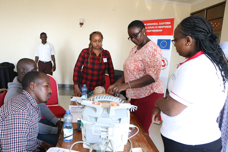 Trainee doctors being shown how to resuscitate a model patient during a training funded by EU and AKDN at a Kisumu Hotel.