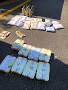 The truck was searched and officials found makeshift compartments in both the truck and trailer in which the drugs as well as bottles of illegal liquor were stashed. 