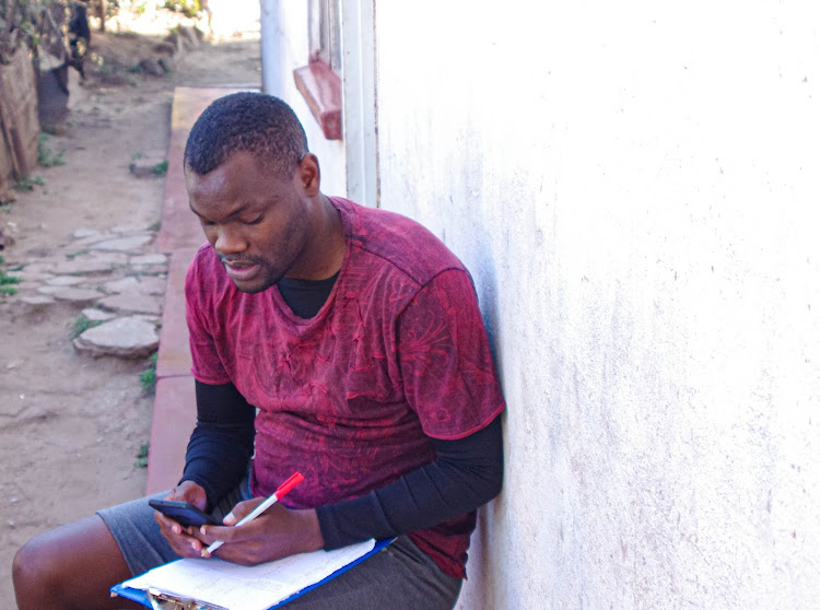 Maxwell Chimedza teaches using WhatsApp at his home in Mbare, one of oldest townships in Harare.