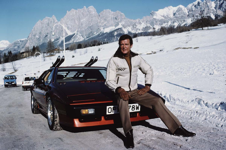 English actor Roger Moore poses as 007, with a Lotus Esprit Turbo, on the set of the James Bond film 'For Your Eyes Only', February 1981. Moore was born in Stockwell, London, England on October 14, 1927. He died aged 89 on May 23, 2017 in Crans-Montana, Switzerland of liver and lung cancer.