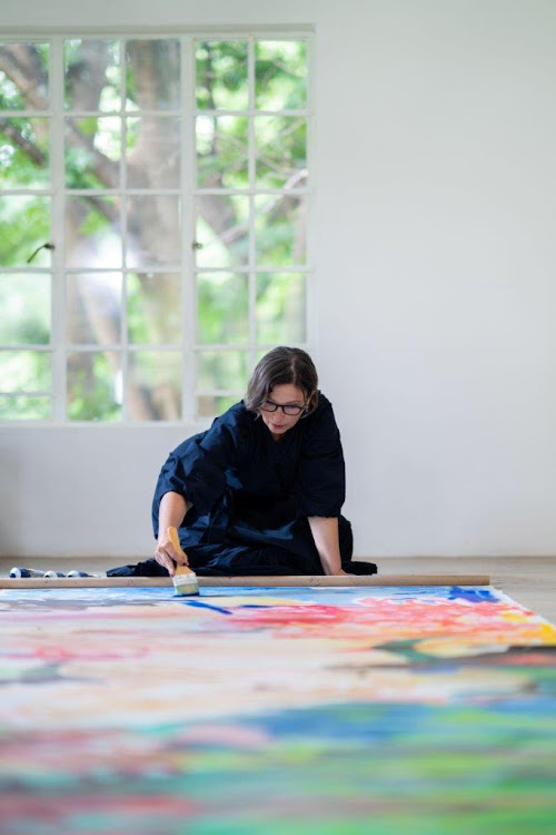 Barry works on one of her large-scale paintings.
