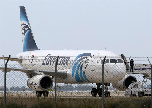 An unidentified airport staff stands on a gangway near the hijacked EgyptAir A320 plane at a sealed off area of the Larnaca Airport, in Larnaca, Cyprus, 29 March 2016. Picture credits: EPA