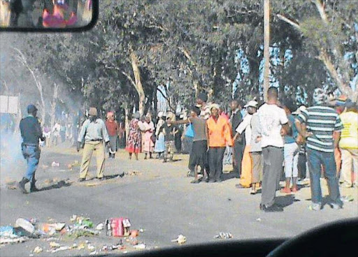 OUTRAGED: Protestors blockade a road and burn rubbish in Bedford Picture: ZWANGA MUKHUTHU