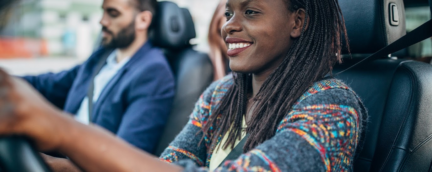 Man and woman in front seat of car.