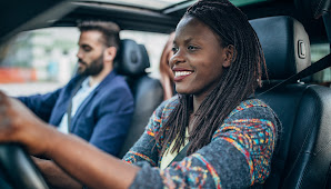 Man and woman in front seat of car.