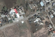 A satellite image shows tanks and armored vehicles hiding by homes, in Kalynivka, Ukraine, March 29, 2022. 