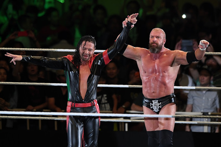 Shinsuke Nakamura and Triple H celebrate the victory during the WWE Live Tokyo at Ryogoku Kokugikan on June 29, 2019 in Tokyo, Japan.