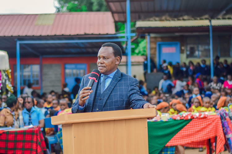 Limuru town school head teacher Bishop David Makimei addressing teachers, pupils and parents during the schools prize giving day.