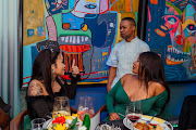 Top chef Wandile Mabaso (centre) mingles with guests at the Spotify event.