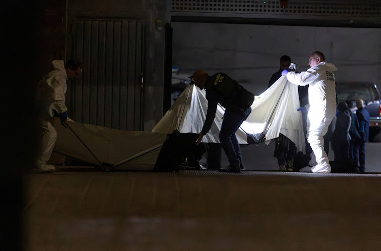 Spanish Civil Guard officers investigate the garage where the body of Russian pilot Maxim Kuzminov was found after he was shot dead, in Villajoyosa, Spain, February 13, 2024.