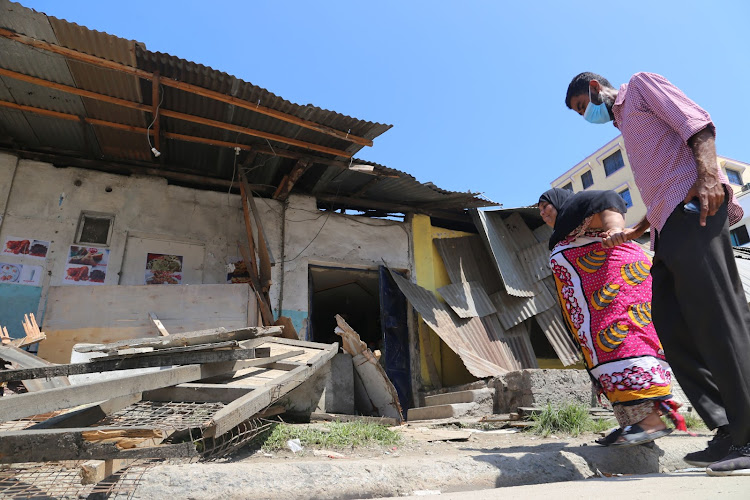 Fatma Ashur and her son Ahmed Faraj outside their demolished house in King'orani on Wednesday.