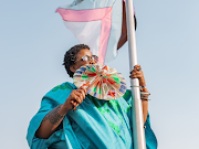 Thandiswa Mazwai raising the rainbow Pride flag at Constitution Hill.