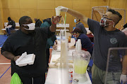 Volunteers hand out meals at a Salvation Army facility after winter weather caused electricity blackouts in Plano, Texas, US. February 18, 2021.  