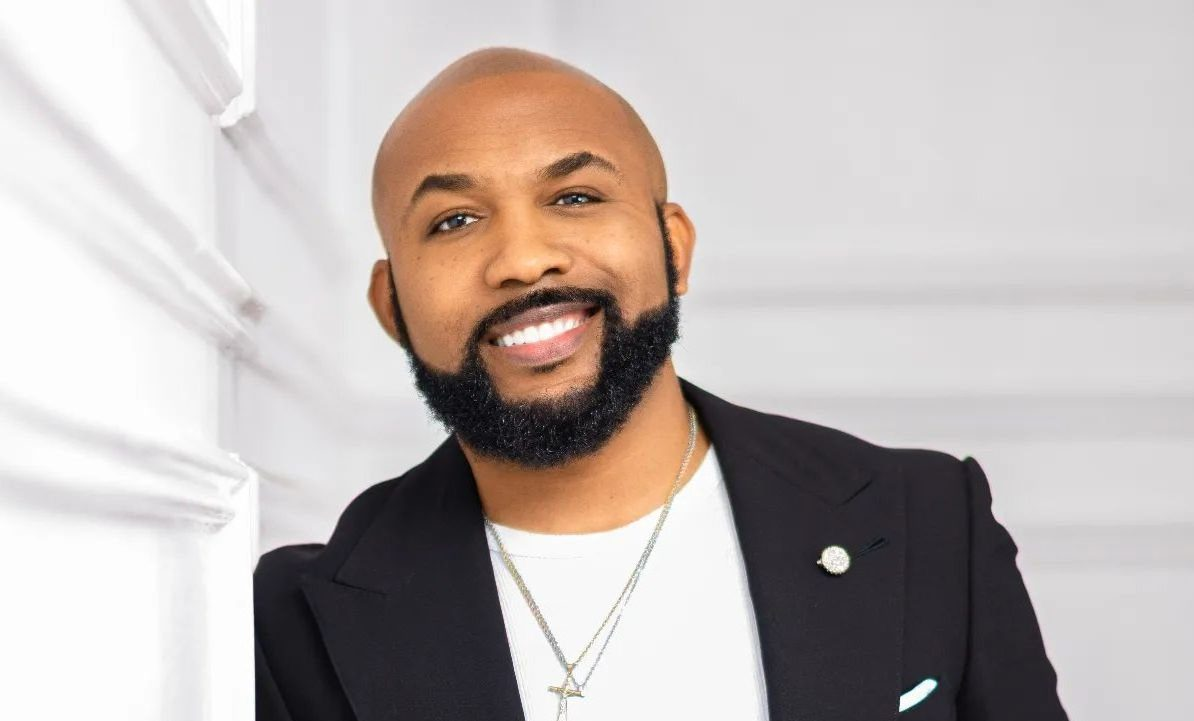 Banky W wearing a suit with his bald hair