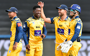 Nqaba Peter and his Lions teammates celebrate his dismissal of Caleb Seleka of the North West Dragons at the Wanderers on Sunday