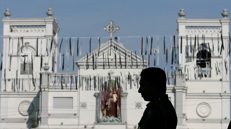 A security personnel observes three minutes of silence as a tribute to victims, two days after a string of suicide bomb attacks on churches and luxury hotels across the island on Easter Sunday, near St Anthony Shrine in Colombo, Sri Lanka April 23, 2019.