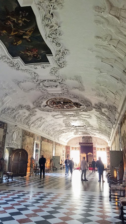 Visiting Rosenborg Castle in Copenhagen. On the third floor and is where you'll find the impressive Throne Room, also known as the Long Hall or Knights’ Hall. It was intended as a ballroom, and here you will find the coronation thrones for the king and queen and three life-size silver lions standing guard. On the other side of the room is displayed the throne for audience.