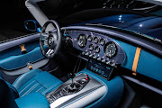 The cabin blends old-school analogue gauges with a modern touchscreen infotainment system.
