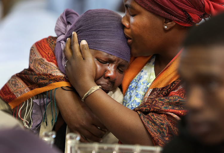 Mourners Prudence Mokoena (Right ), comforts Felicity Nkonyana at a memorial service for the slain 12 taxi drivers who were killed along the R74 between Colenso and Weenen, the memorial service was held near Rabie Ridge, Tembisa on July 26 2018