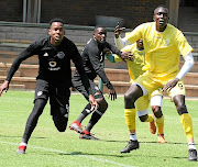 AmaTuks' striker Mame Niang, right,  is marked by  Pirates players Happy Jele and Ntsikelelo Nyauza during a friendly last week.