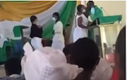 A screenshot of a video showing a church leader in Ghana kissing students.