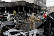 Emergency services work next to a damaged civil infrastructure building at the site of a Russian military strike in Vinnytsia, Ukraine, on July 14 2022. 