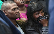 Juanita Pieters (R, late Courtney Pieters mother) and her husband is pictured at accused Mautimer Saunders court appearance at the Goodwood Magistrate Court for the alleged murder of three-year-old Courtney Pieters on May 17, 2017 in Cape Town, South Africa. Courtney Pieters' body was discovered by a search party in Bofors Circle, Epping. CCTV footage allegedly revealed the 40-year-old suspect carrying Pieters and dumping her body at the Epping industrial site.