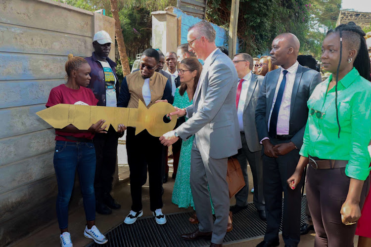 Hon. Ababu Namwamba, Cabinet Secretary for Youth Affairs, Creative Economy and Sports, and Amb. Sebastian Groth, Ambassador of the Federal Republic of Germany to Kenya, officially open the Anno's One Fine Day Arts Center in Kibera. Looking on are Henriette Geiger, European Union Ambassador to Kenya, Timothy Owase, CEO of the Kenya Film Commission, and Krysteen Savane, Founder of Anno's One Fine Day.