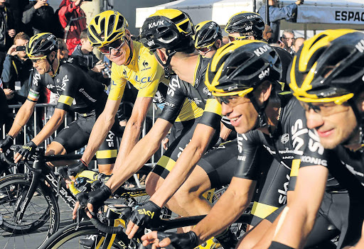 LINES OF COMMAND: Tour de France winner Chris Froome (in yellow) of Great Britain and Team Sky and his teammates cross the finish line during stage 21 of the prestigious race, a 109.5km stretch from Sevres to the Champs Elysees Avenue in Paris on Sunday