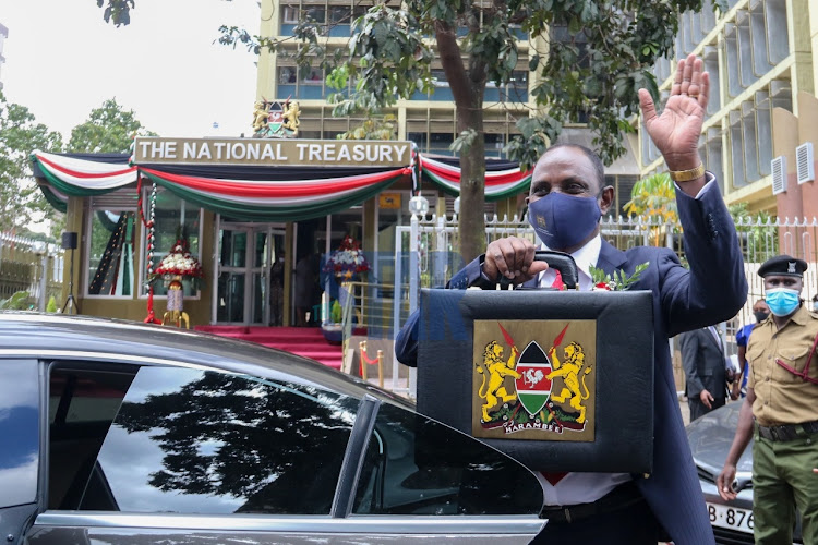 CS Ukur Yatani poses for a photo holding the Budget briefcase outside Treasury Buildings along Harambee Avenue before proceeding to Parliament ahead of Budget reading on Thursday, 10 June./WILFRED NYANGARESI