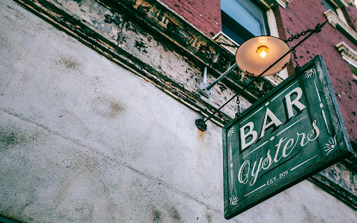 Signboard with Bar inscription on old building wall in town screenshot 1