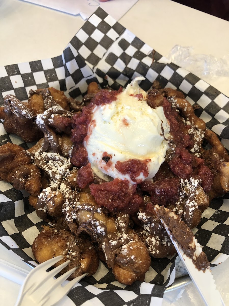 Gluten-free funnel cake, made in a dedicated deep fryer. With Nutella, vanilla ice cream and strawberry compote.