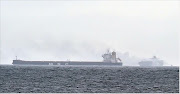 Smoke can be seen billowing from the ship