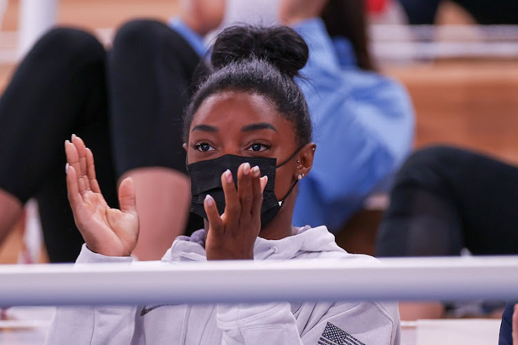 Simone Biles of Team United States looks on while cheering on teammate Sunisa Lee in the women's all-around final at the Tokyo Olympic Games at Ariake Gymnastics Centre.