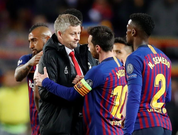 Manchester United manager Ole Gunnar Solskjaer with Barcelona's Lionel Messi