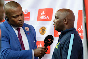 Robert Marawa speaks to Pitso Mosimane during the Absa Premiership match between Kaizer Chiefs and Mamelodi Sundowns at FNB Stadium on January 09, 2016 in Johannesburg, South Africa.