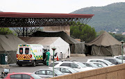 An ambulance is parked near tents erected at the parking lot of the Steve Biko Academic Hospital, amid a nationwide coronavirus disease (Covid-19) lockdown, in Pretoria, South Africa, January 11, 2021.