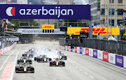 Max Verstappen leads Sergio Perez and the rest of the field into turn one at the safety car restart during the F1 Grand Prix of Azerbaijan at Baku City Circuit on June 6, 2021 in Baku.