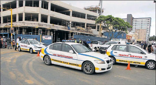 BCM traffic and law enforcement officers blockade the Caxton Street rank in East London yesterday after taximen hurled threats at each other. Picture: MALIBONGWE DAYIMANI