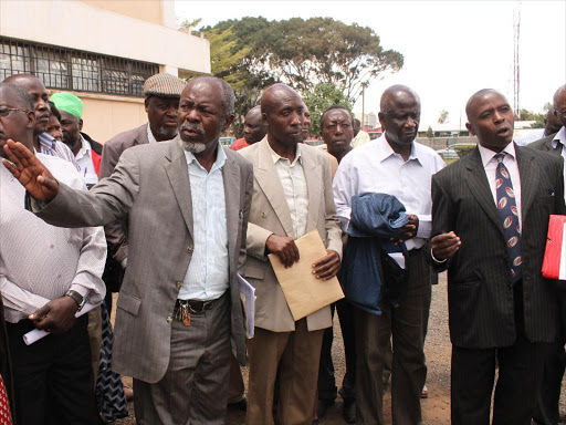 Lucas Ondonye,chairman Kenya railways staff retirement benefit scheme(3rd left) with his members at their headquarters Sep 12 2013 when they were demanding information on the sale of three properties.Photo/Philip kamakya