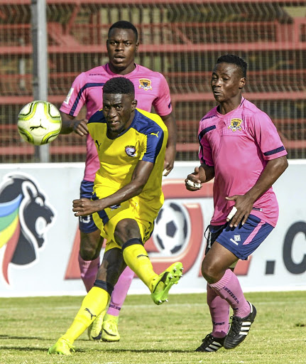 Denzil Haoseb of Jomo Cosmos takes a shot despite the attention of Black Leopards players during their promotion playoff yesterday.