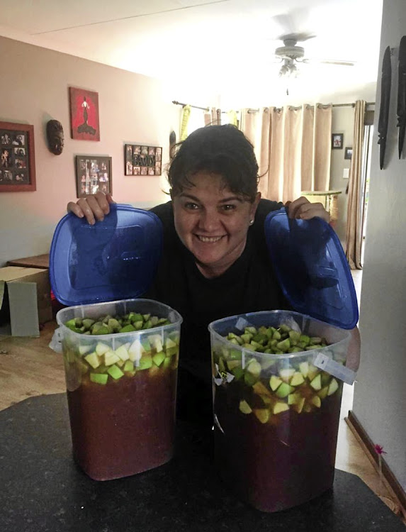 Colleen Foyn shows off her home-brewed alcohol.