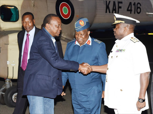 President Uhuru Kenyatta with by Lieutenant-General Samson Mwathethe and Chief of Defence Forces-Designate and the outgoing CDF, Gen. Julius Karangi at J.K.I.Airport Apr 24 2015 shortly before leaving for an official visit to Los Angeles, U.S.A to attend the 2015 Milken Global Conference. Looking on is Interior CS (Rtd) Major General Joseph Nkaissery on Thursday Photo/PSCU