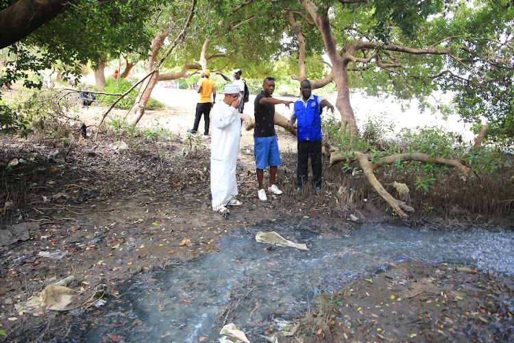 Muhuri director Khelef Khalifa, Sammy 'Moddy' Ounda and Muhuri officer Francis Auma at Tudor beach on Wednesday.