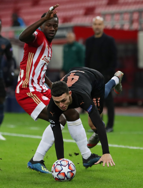 Manchester City's Phil Foden in action with Olympiacos' Mady Camara